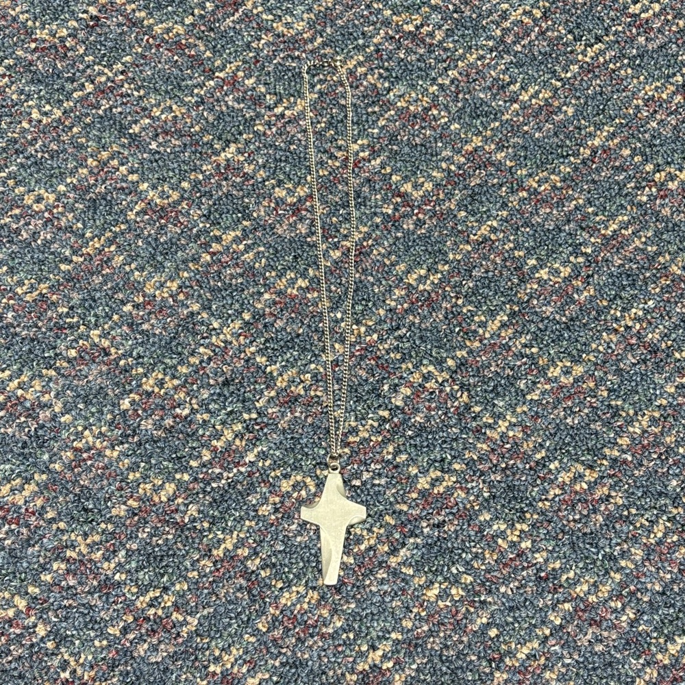 By j rauscher silver colored cross necklace